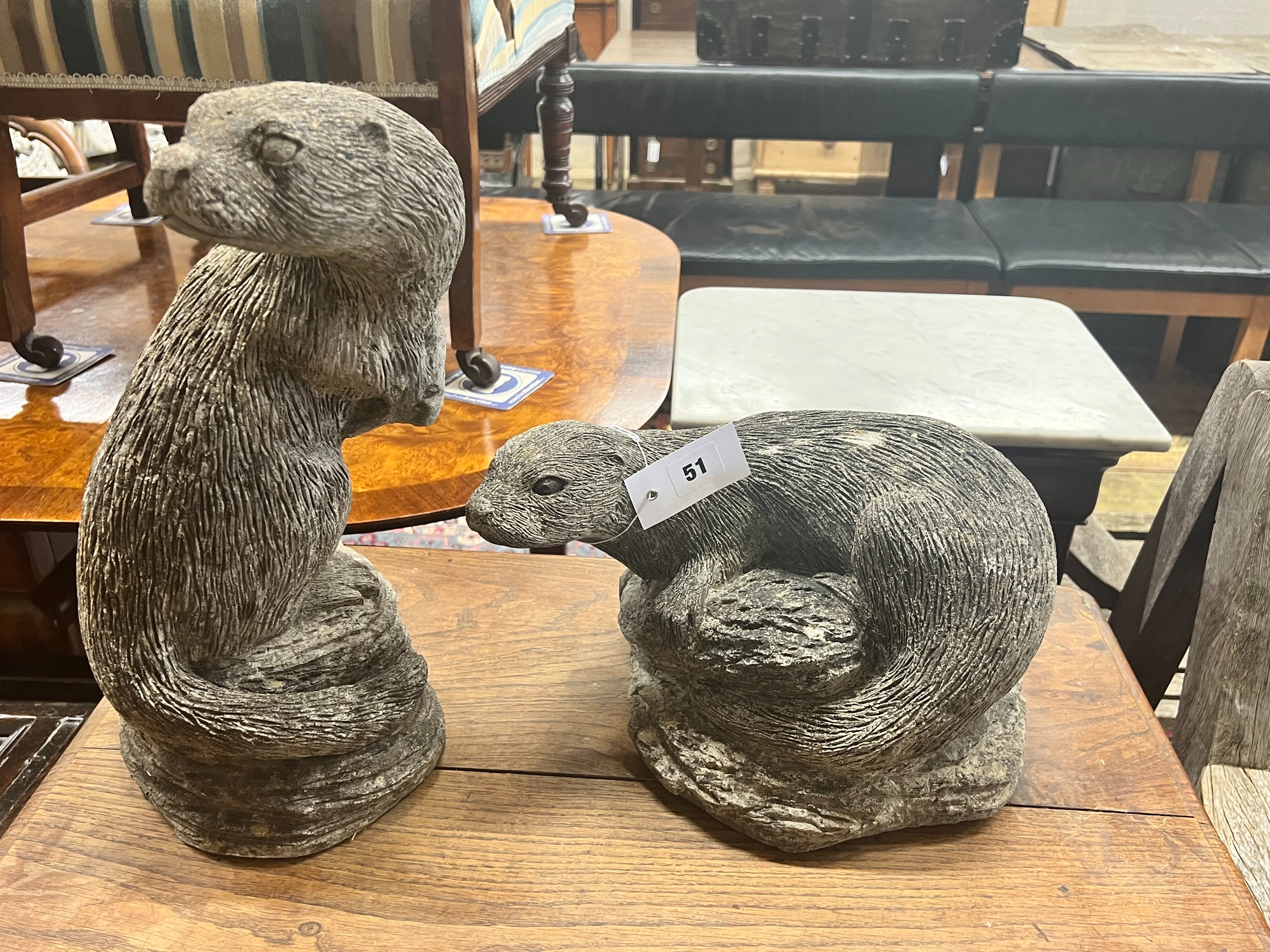 Two reconstituted stone otter garden ornaments, tallest 40cm